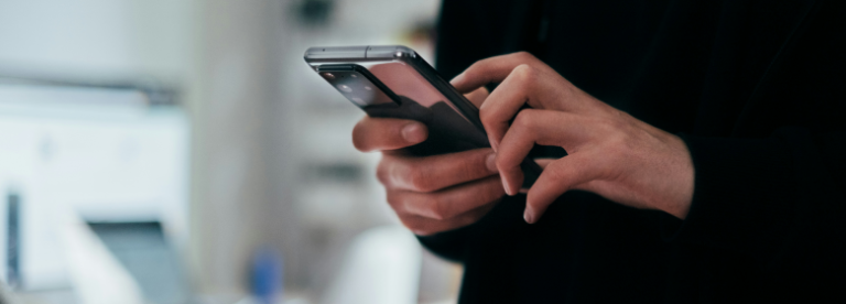 person's hands holding mobile phone